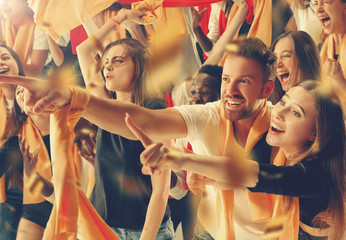 Group of happy fans are cheering for their team victory