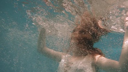 Wall Mural - Girl in a white lace dress under water