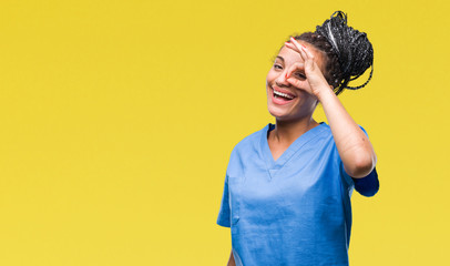 Sticker - Young braided hair african american girl professional nurse over isolated background doing ok gesture with hand smiling, eye looking through fingers with happy face.