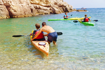 kayaking and canoeing school. unidentifiable professional instructor teaching a beginner