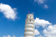 Leaning Tower Torre Di Pisa On Piazza Del Miracoli Square, Blue Sky With White Clouds Background In Beautiful Sunny Day, View From Below Close-up Copy Space Isolated, Tuscany, Italy