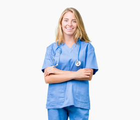 Beautiful young doctor woman wearing medical uniform over isolated background happy face smiling with crossed arms looking at the camera. Positive person.