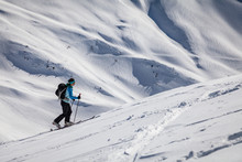 A young woman is going for some ski touring in the backcountry.