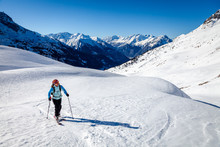 A Young Woman Is Going For Some Ski Touring In The Backcountry.