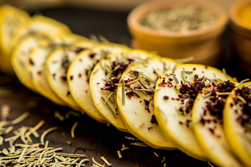 squash yellow cut slices seasoning spices herbs rosemary sumac taste raw diet taste traditional ingredients wooden