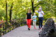 © angor75 - Blurred Image of Four People Family Walk on a Bridge In Park.