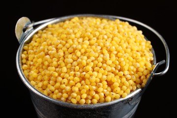 Sticker - Millet in a bucket on a dark background