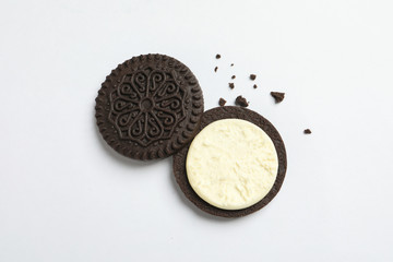 Tasty chocolate cookie with cream on white background, top view