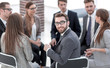 © ASDF - young employee sitting in a circle of colleagues