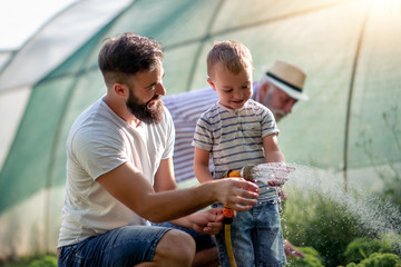 Wall Mural - Father and his son watering plants