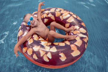 Cute boy having fun in water