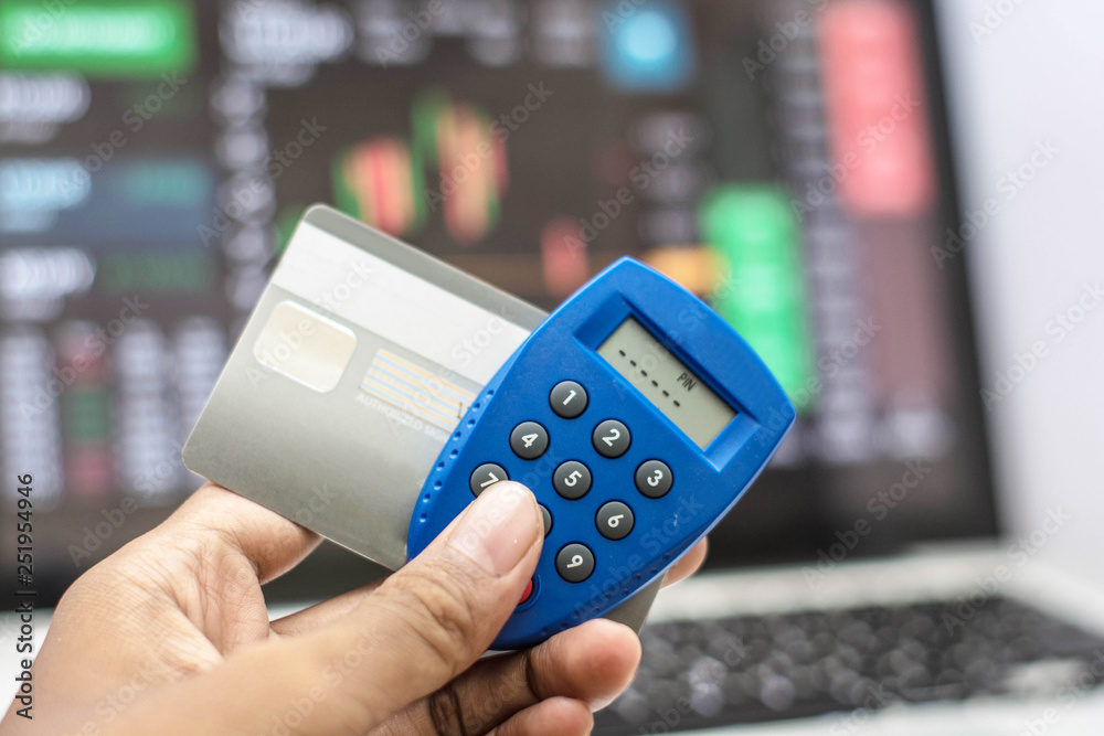 hand holding phone and internet security key and atm card with monitor ...