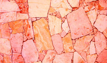 Closeup Of Trendy Coloured Living Coral, Orange And Pink Abstract Sandstone Mosaic Wall. For Pattern, Texture And Background