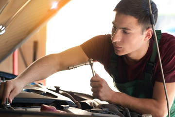 Sticker - Young auto mechanic repairing car in service center