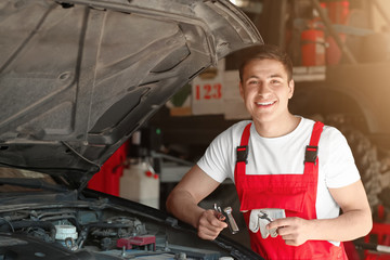 Sticker - Young auto mechanic repairing car in service center