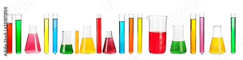 Fotografía Laboratory glassware with color samples on white background