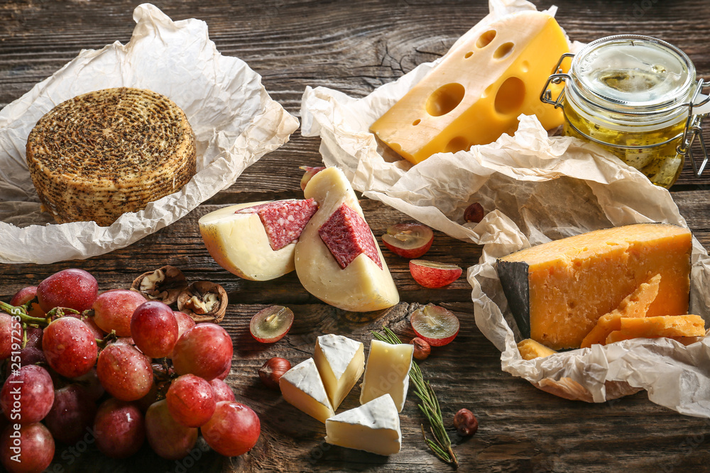 Assortment of tasty cheese on wooden table