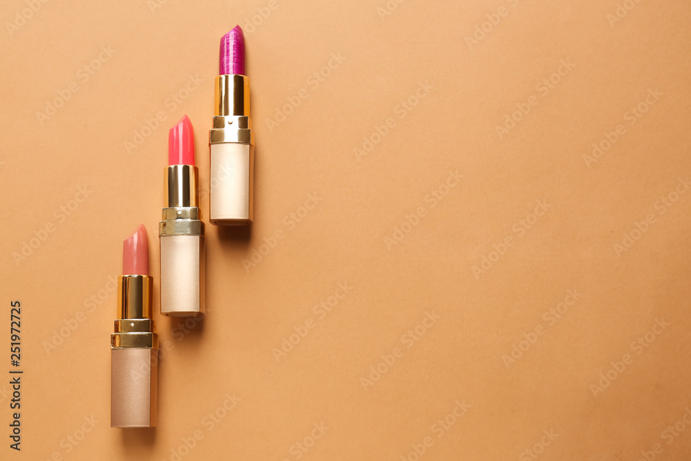 Different lipsticks on color background