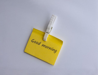 Good morning written on a clipped yellow note