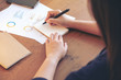 © Farknot Architect - A businesswoman writing on notebook and working on business data and document on the table in office