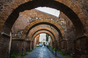 Wall Mural - Ancient street with arches in the center of Rome