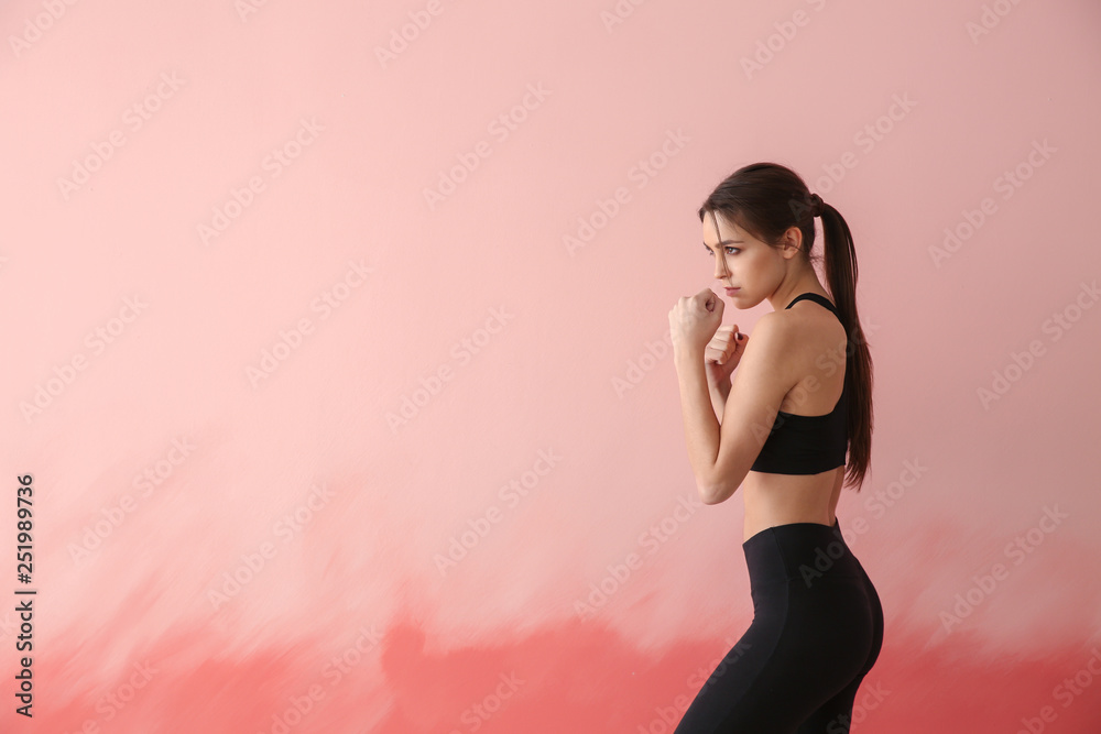 Sporty female boxer on color background