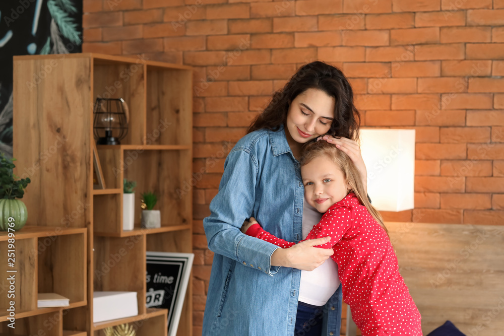 Pregnant mother with little daughter at home