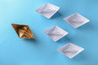 © Pixel-Shot - Golden paper boat among white ones on color background. Concept of uniqueness
