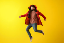 Fashionable Jumping Young Man On Color Background