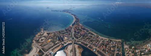 Cuadros en Lienzo Aerial panoramic photo of buildings, villas and the beach on a natural spit of L