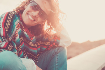 Cheerful caucasian pretty middle age woman smiling and enjoying the sunset outdoor - sun in backlight and happiness - travel and vacation concept for nature lifestyle people