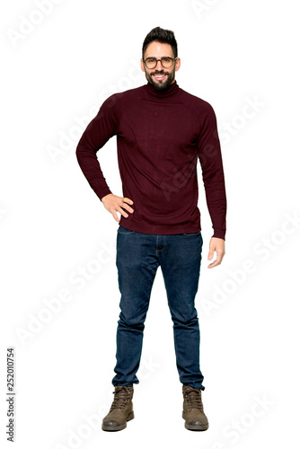 Zdjęcie: Full-length shot of Handsome man with glasses posing with arms at hip and smiling on isolated white background Full-length shot of Handsome man with glasses posing with arms at hip and smiling on isolated white background