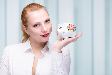 Wall Mural - young woman with piggy bank