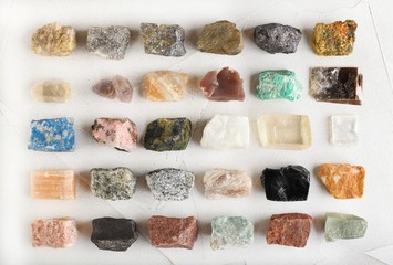 Set of minerals, a collection of rocks, minerals in the box on white cement background.