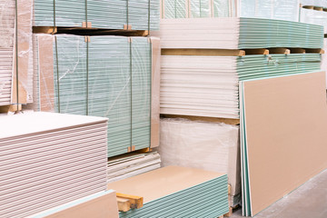 Gypsum plasterboard in the pack. The stack of gypsum board preparing for construction. Pallet with plasterboard in the building store. Construction Materials. Drywall warehouse