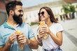 Young couple is eating sandwiches and having a great time