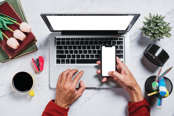 Wall Mural - flat lay, top view desk table.man using mobile phone at marble desk table with blank screen laptop c