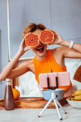 Wall Mural - Nice joyful woman cooking in the kitchen