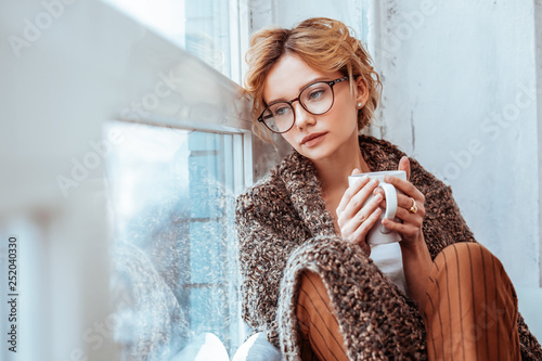 Fotografía Sad cheerless woman being covered with plaid