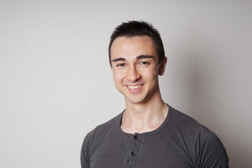 Wall Mural - happy smiling young man looking at camera                      