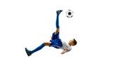 Fototapeta Sport - Young boy with soccer ball running and jumping isolated on white studio background. Junior football soccer player in motion