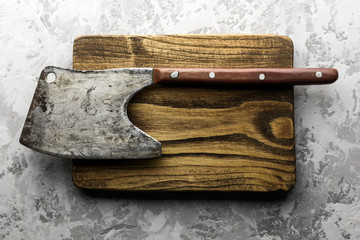 Wall Mural - Old rustic axe for meat on a wooden board on grunge background. Food photography