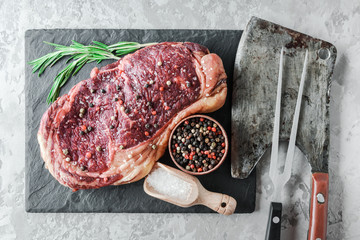 Wall Mural - Marbling ribeye steak on white wood plate. Prime rib beef chop