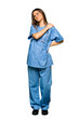 © luismolinero - Full body of Young nurse suffering from pain in shoulder for having made an effort