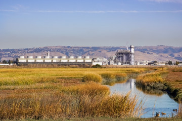 The marshes of East San Francisco bay; on the background the city power plant, Hayward, east San Francisco bay area, California