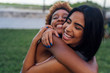 © Westend61 - Portrait of two happy female friends hugging in a park