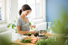 Woman Preparing Healthy Food In Her Kitchen