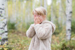 © Westend61 - Blond girl playing Hide and Seek in a forest
