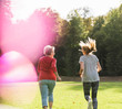 © Westend61 - Granddaughter and grandmother having fun, jogging together in the park