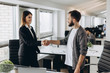 © JJ Studio - Young business people shaking hands in the office. Finishing successful meeting.